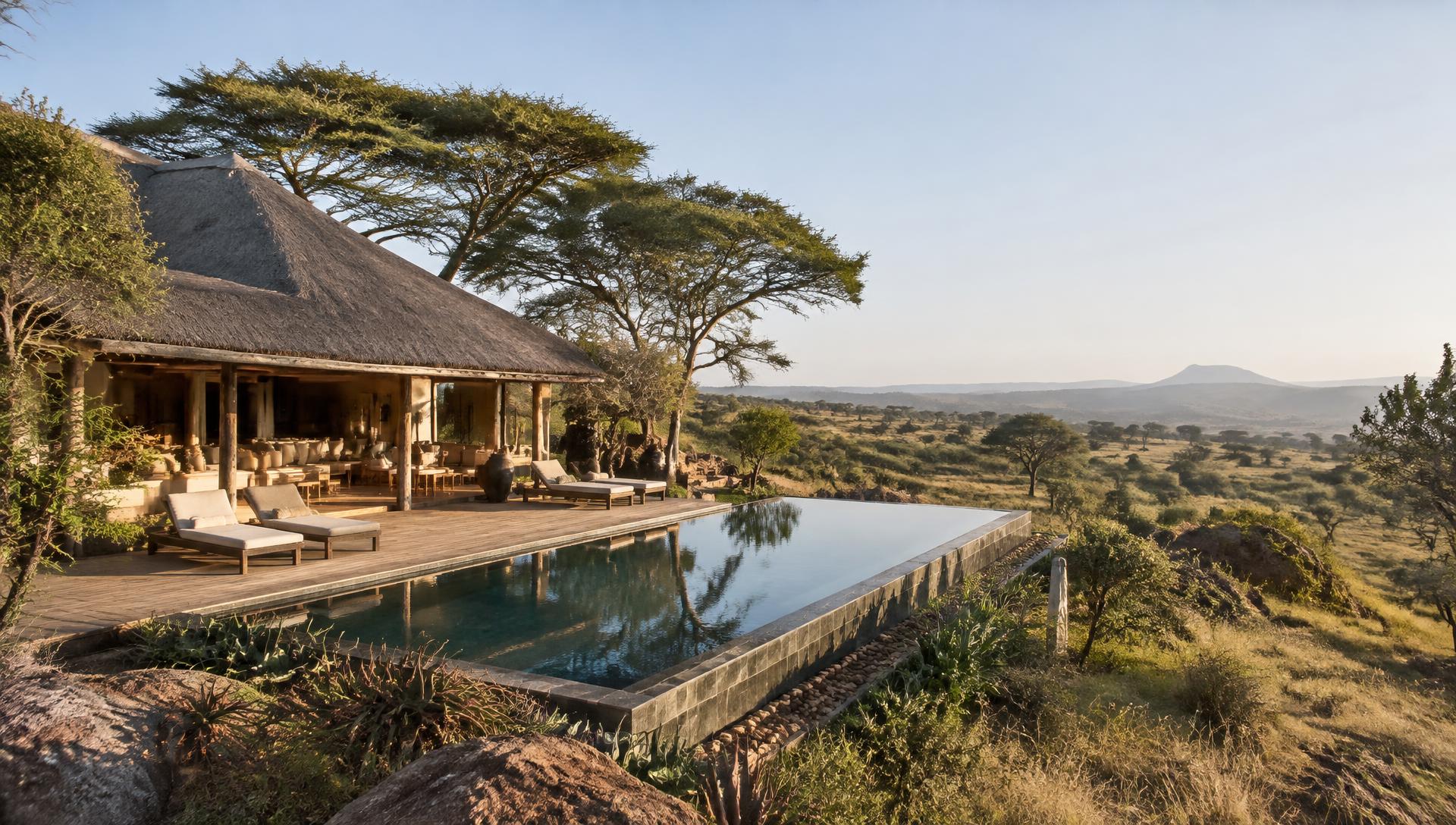 An exclusive-use safari residence with a long infinity pool and acacia trees overlooking the plains of Laikipia